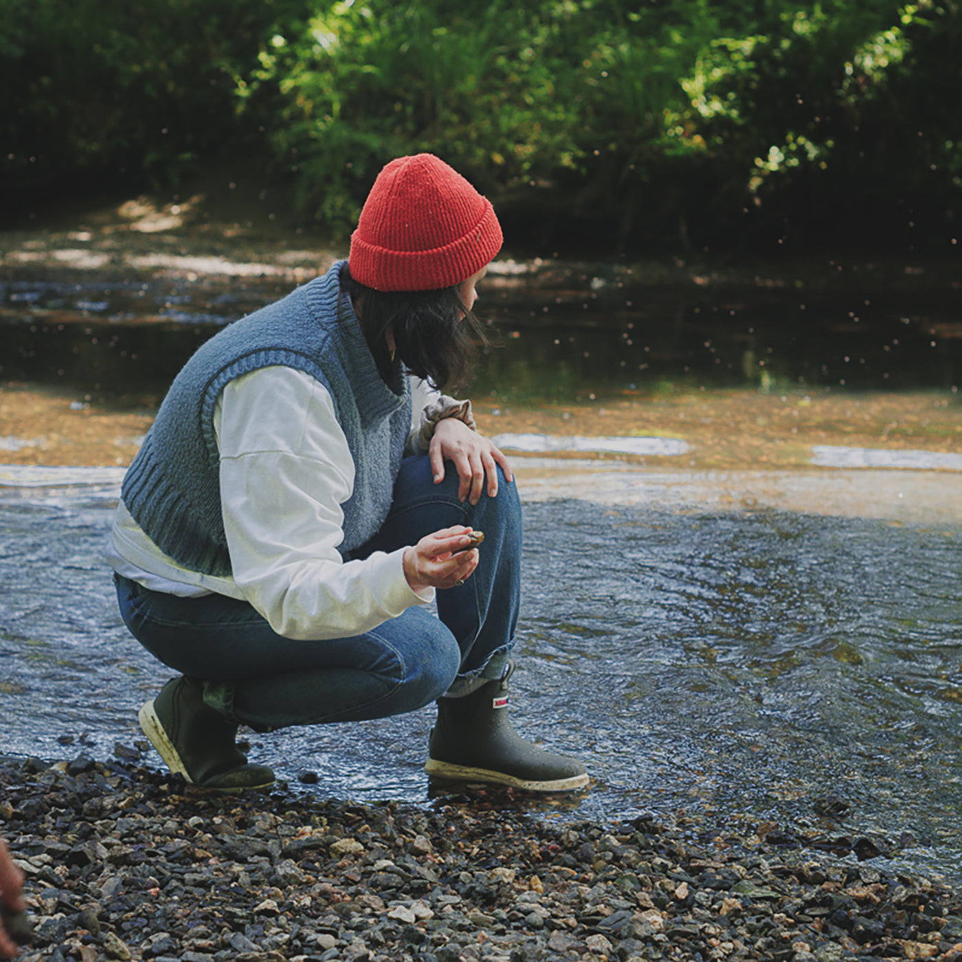 Ankle Deck Boot Sport worn beside a stream; the pale BioLite outsole is visible beneath the rubber upper.
