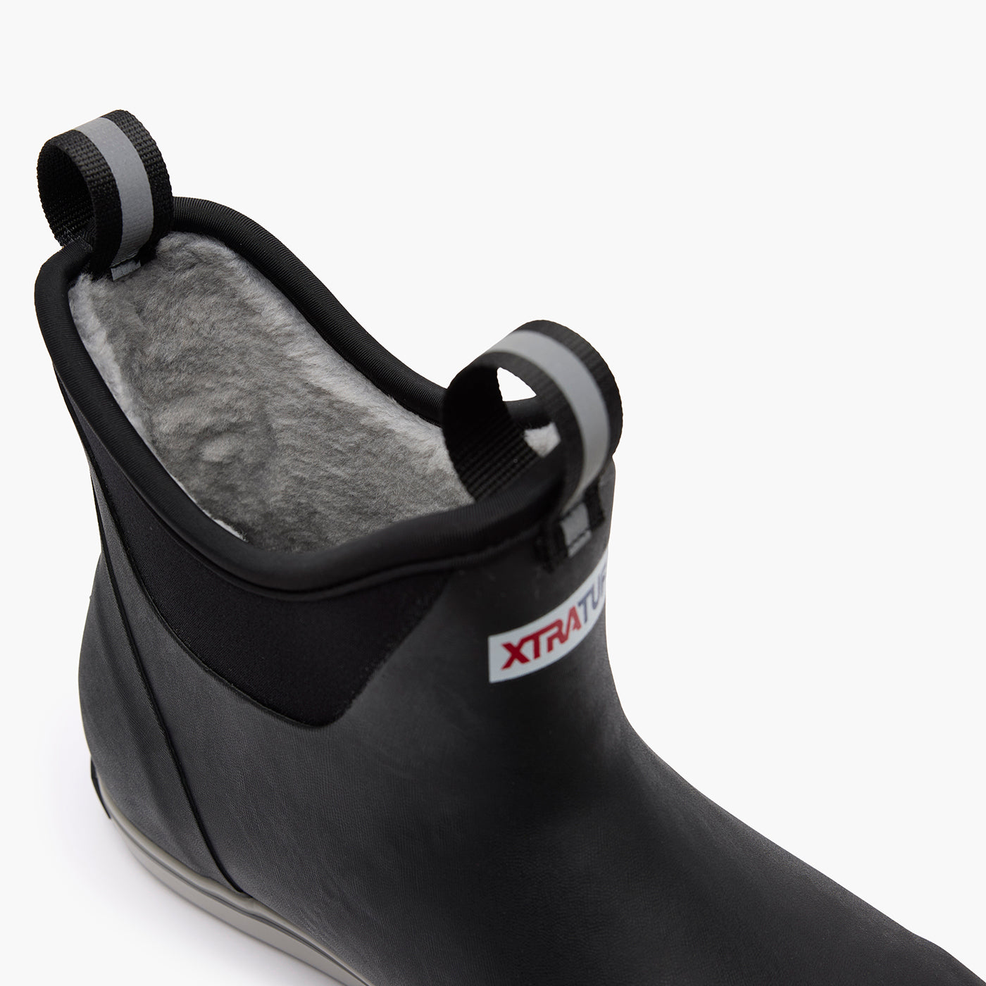 Close-up of the plush gray faux-shearling lining inside a black XTRATUF ankle boot.